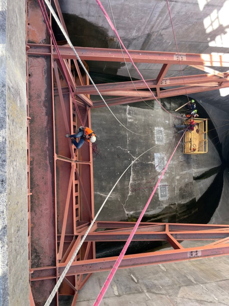 rope access technician lowered into damn spillway